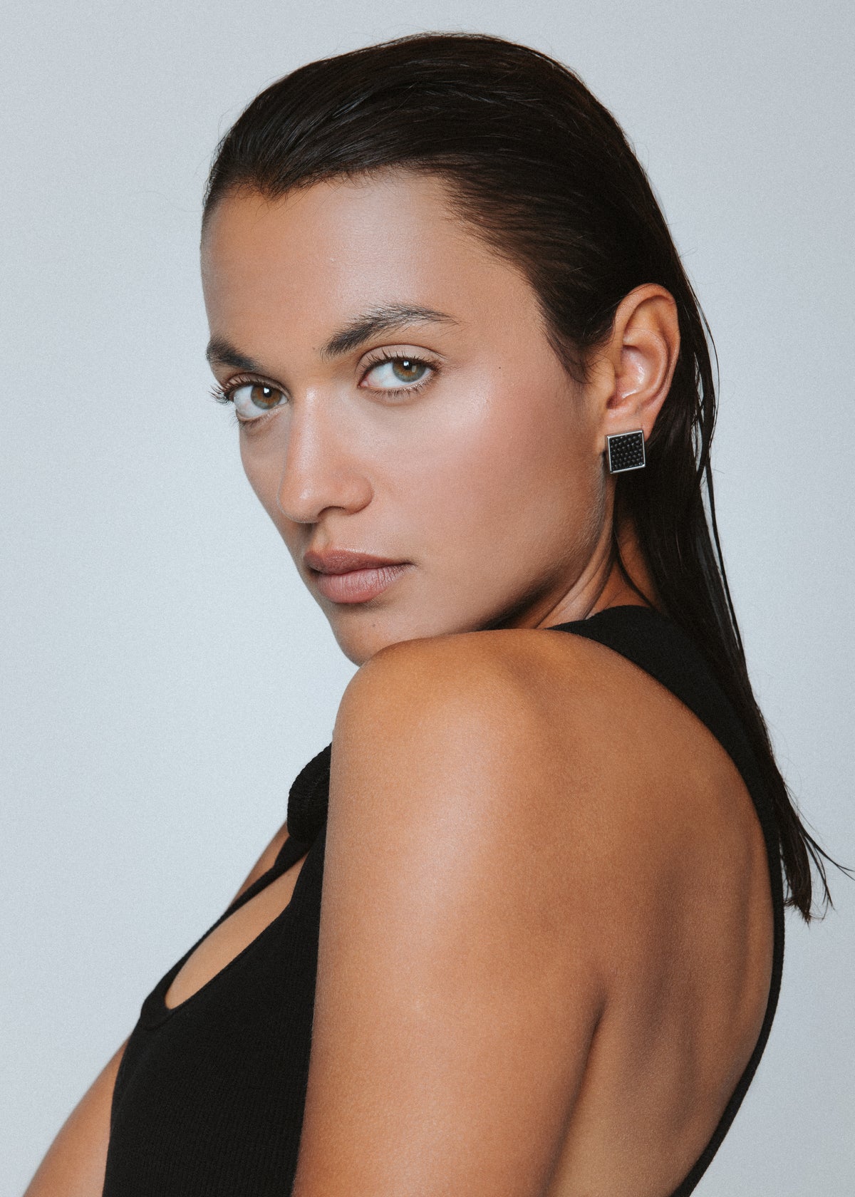Detailed view of the silver finish and black leather on Vesper Mini Earrings